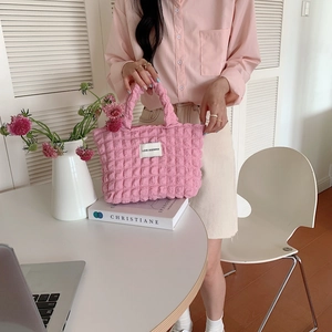 Close-up of pink bubble texture canvas bag with Love Sozakka woven label detail
