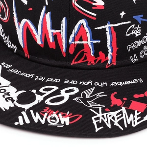 Detailed macro view of black twill baseball cap with colorful street graffiti print