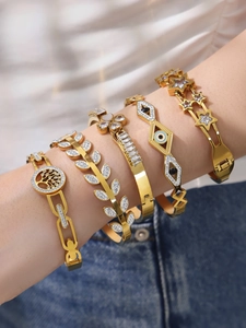 Detail showing 18k gold plated bracelet set with heart, flower and zircon leaf patterns