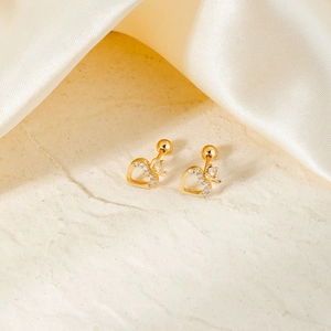Exquisite gold heart earrings with crown zircon stone on beige stone and white silk