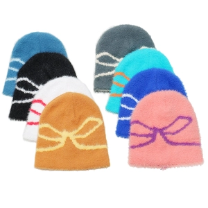 Winter beanie set for women featuring soft plush fabric and jacquard bow design