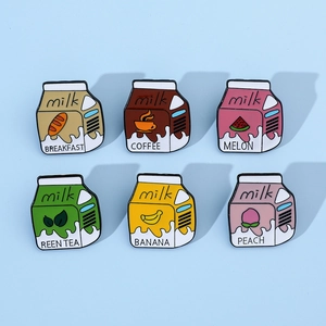 Close-up of six creative cartoon milk carton enamel pins in various fruit flavors