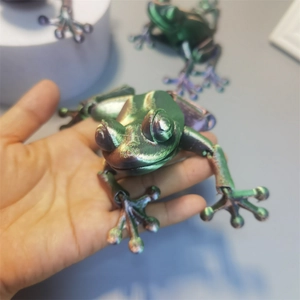 Detailed macro view of 3D printed articulated frog toy with gradient metallic texture
