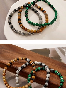 Detailed view of natural malachite and marble stone beads with metal spacers on textured wood