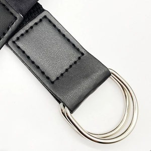 Close-up of black canvas belt with double silver D-ring buckles for dresses