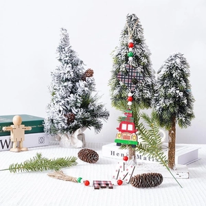 Detailed view of artificial Christmas trees with red car wooden pendants and bead strings