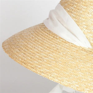 Classic Hepburn style wide brim straw hat with elegant white chiffon ribbon tie for beach