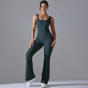 Detail of dark green backless yoga jumpsuit featuring flared legs and high-stretch fabric