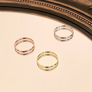Faceted sparkling stackable titanium rings in rose gold, gold, and silver finishes