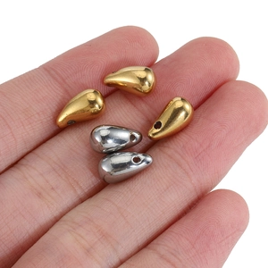 Handheld view of 18k gold and silver plated stainless steel water drop pendants for DIY jewelry