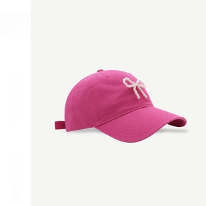 Detail of rose pink baseball cap with pearl bow decoration and adjustable cotton strap