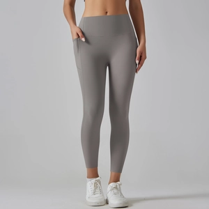 Detail view of high waist yoga pants in grey with functional side pockets for gym workouts