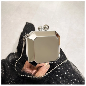 Close-up of silver octagonal mirror evening bag with ball clasp and spherical chain