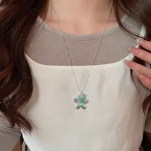 Floral necklace with green cat-eye stone and blue beads on a delicate silver bead chain