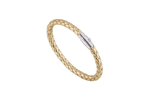 Macro detail of golden woven texture and silver magnetic clasp on a PU leather bracelet