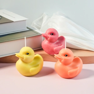 3D cute duck scented candles in yellow, pink and orange on a wooden stand