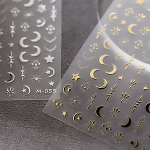 Embossed gold and silver nail art stickers with moon and star celestial patterns