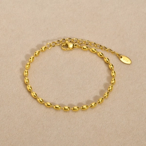 Detailed macro shot of a golden K18 stainless steel ball chain bracelet with extension