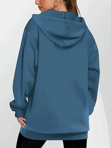 Rear view of a blue loose-fit longline hoodie featuring a comfortable hood and long sleeves