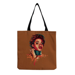 Close-up of reusable brown canvas tote bag with artistic printed female portrait