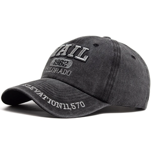 Vintage washed cotton baseball cap with VAIL embroidery and distressed finish in grey