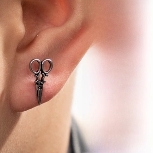 Detailed close-up of retro silver stainless steel scissors earring with antique finish