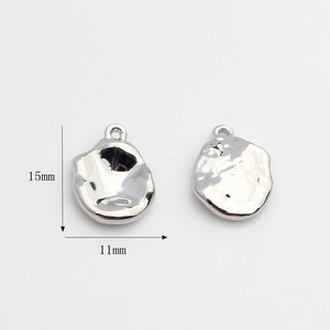 Detail view of 15mm by 11mm silver irregular oval star charms for DIY jewelry making