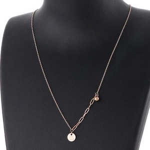Detail of rose gold stainless steel necklace with Good Luck engraved pendant and bead chain