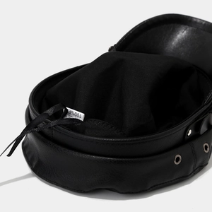 Detail view of black PU leather military cap featuring fabric lining and size 58 label