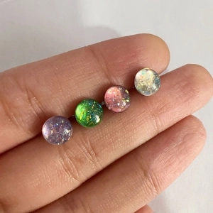 Sparkly titanium steel ball tongue rings in purple, green, pink, and white opal colors
