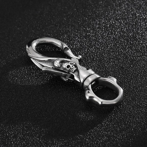 Close-up of vintage silver stainless steel skull keychain with a spring snap hook