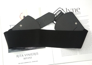 Detail of black elastic wide waist belt with PU leather buckle and metal snaps on top
