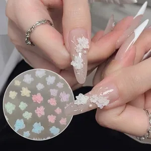 Macro shot of 3D 5-petal flower nail charms with pearls in various macaron colors