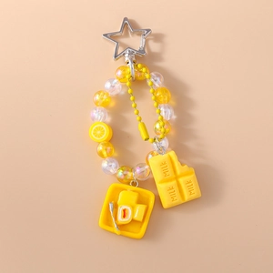Detail of yellow beaded keychain with lemon slice and milk chocolate bar charms