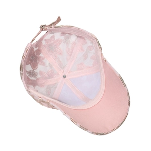 Detailed side view of pink floral lace mesh baseball cap with adjustable metal buckle