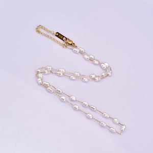 Detailed macro view of Baroque pearl necklace with K18 engraved gold clasp