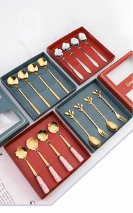 Detail of floral stainless steel dessert spoons and forks in premium gift box packaging