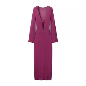 Detail of fuchsia knit dress featuring a deep V-neck and a metallic ring hardware accent