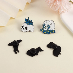 Detail of enamel pins showing the celestial skull front and black rubber clutch backing