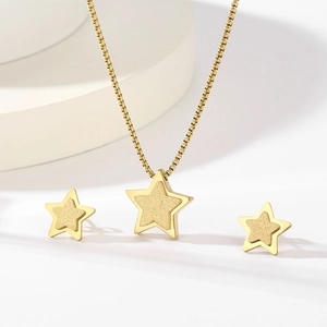 Close-up of golden star jewelry set featuring frosted and polished textures on the pendant