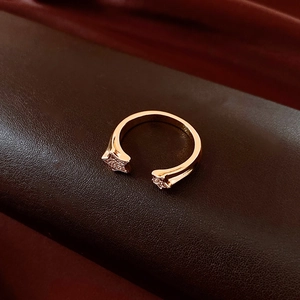 Detail of 18k gold plated star open ring set with sparkling pave-set zircons on dark leather
