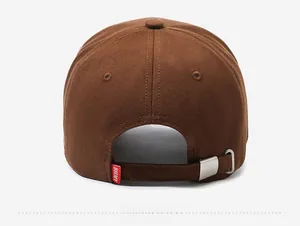 Detail view of brown baseball cap back with metal adjustable strap and small red brand tag