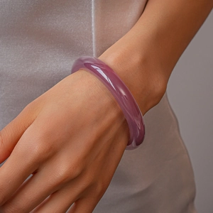 Close-up of minimalist translucent purple resin bangle worn on a female wrist