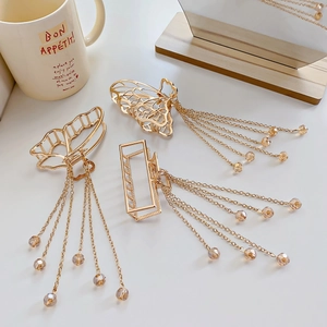 Three-piece set of golden butterfly metal hair claws with pearl fringe and tassels