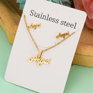 Detailed macro view of golden stainless steel necklace and earrings set with Angel pendant