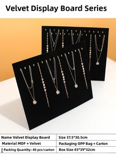 Macro shot of 37.5x30.5cm black velvet jewelry display board with metal hooks for necklaces