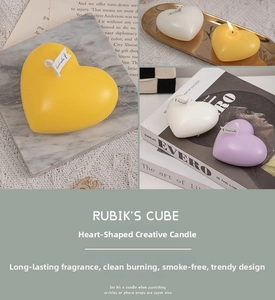 Detailed view of colorful heart-shaped scented candles arranged on a marble tray