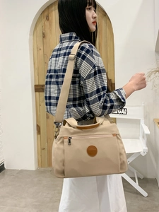 Fashionable beige nylon crossbody bag with adjustable strap and multi-pocket design