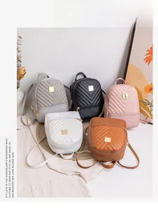 Collection of small synthetic leather backpacks with V-quilted texture and gold metal details