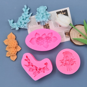 Three pink floral silicone molds for scented candles and resin crafts on blue background